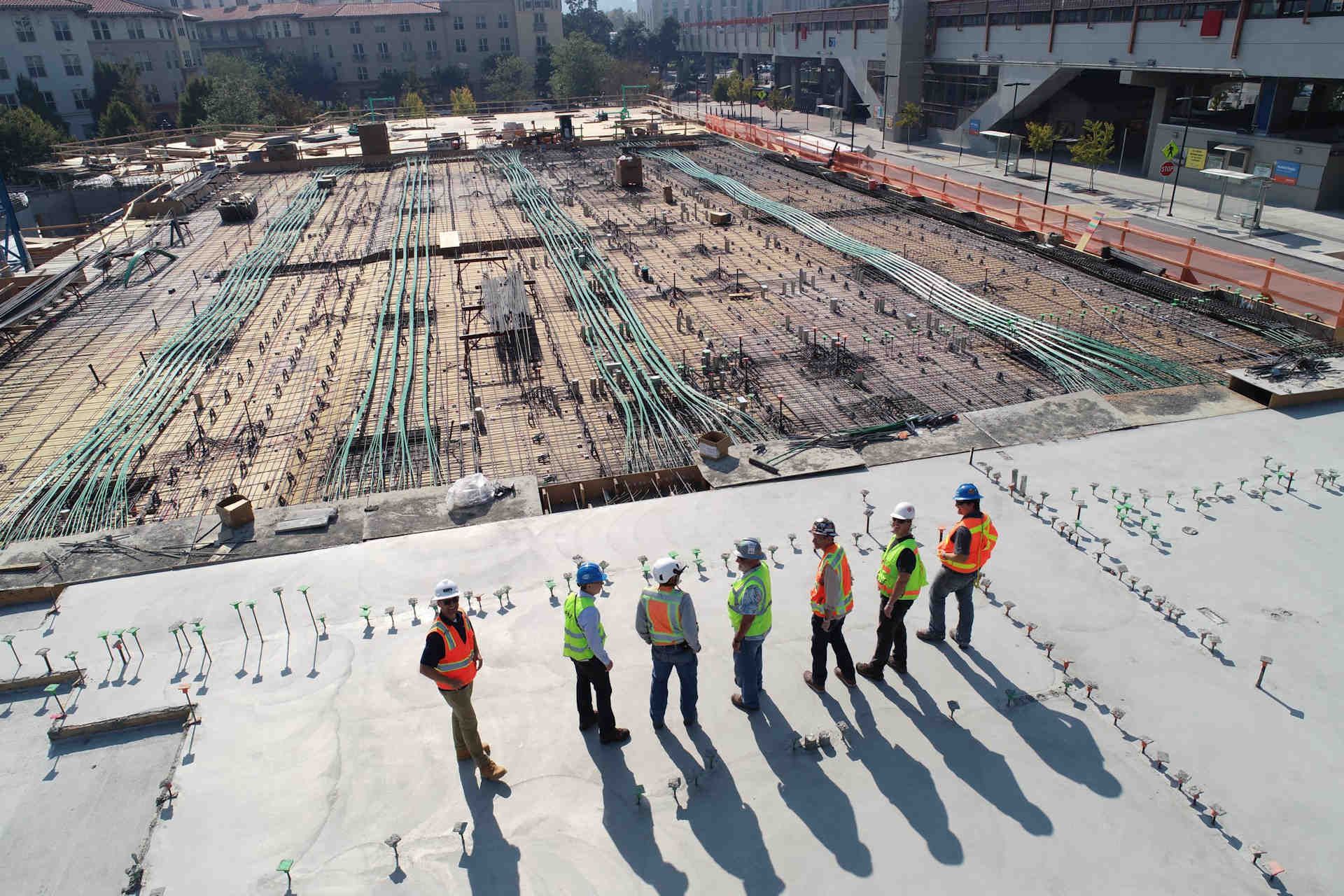 Workers in safety gear shape the foundation with precision, representing Oakley Construction’s professional and reliable contracting services
