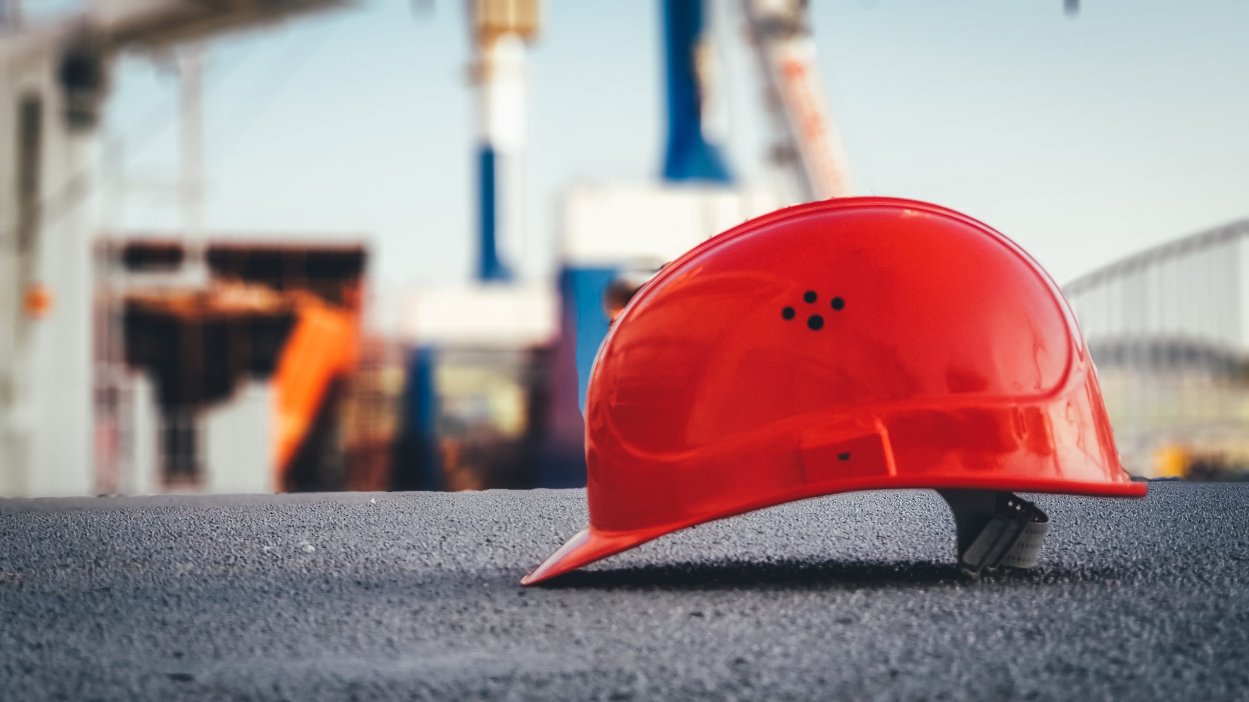 Oakley Construction red hard hat symbolizing reliable Nashville-based general contracting and concrete services